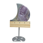 Crescent moon purple druzy agate geode on stand shown with ruler