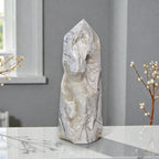 White lace agate style stone tower with pointed top and central hollow