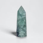 Fluorite crystal tower with pointed top, translucent light green with faceted pattern