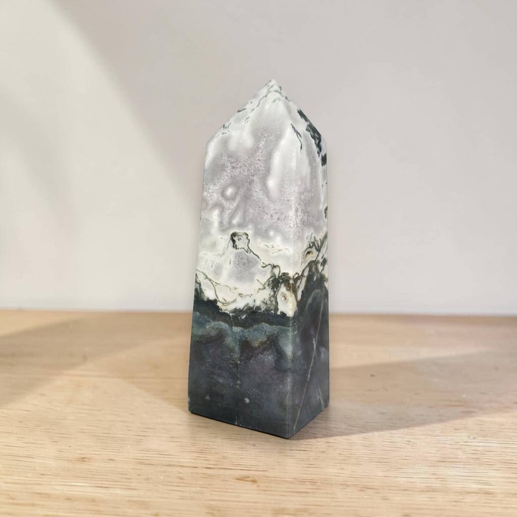 Polished moss agate tower, glossy white surface with dark banding and green-gray growth lines