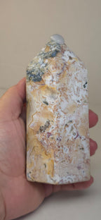 Polished ocean jasper obelisk with cream base and blue-gray, tan, and speckled veining.