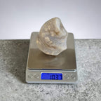 Agate flame crystal on a digital scale, clear beige with white druzy inclusions