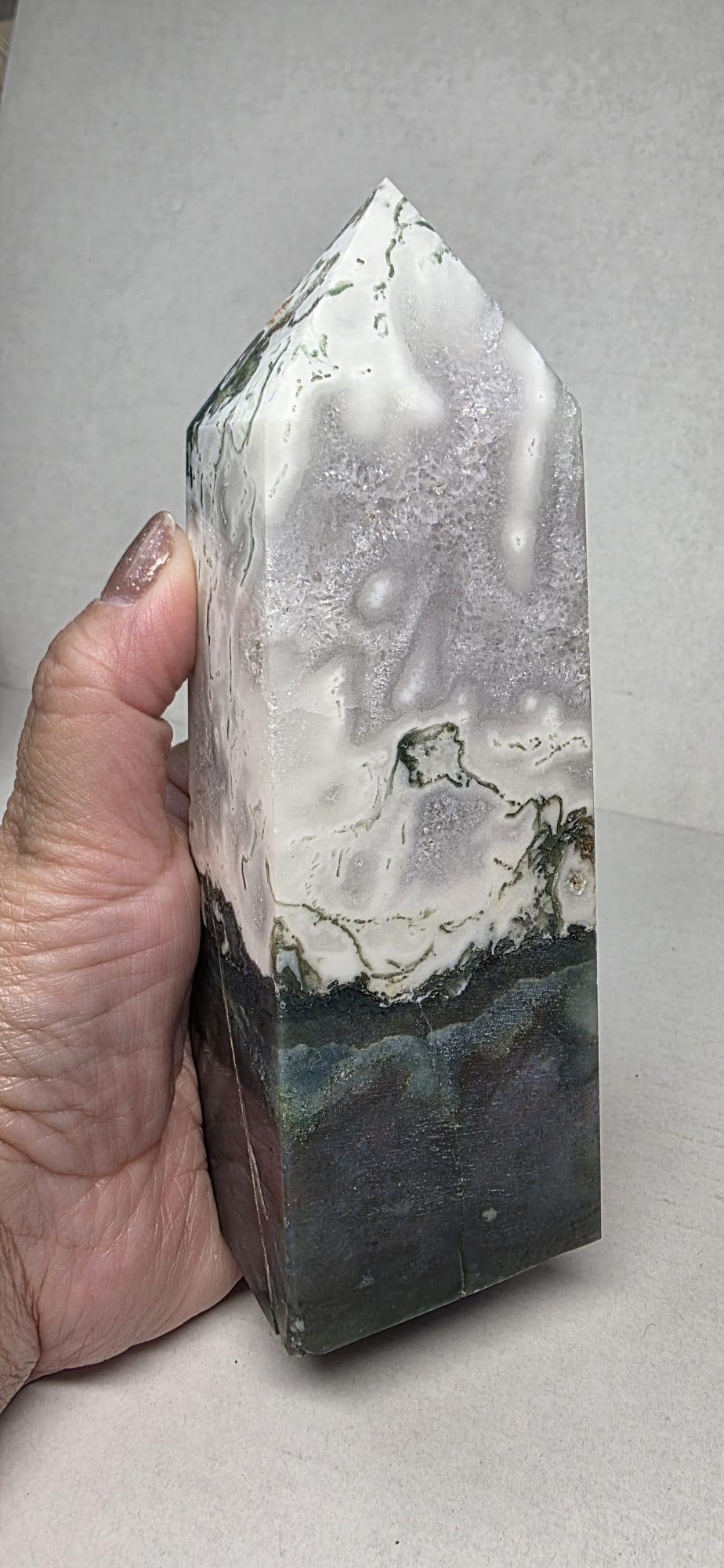 Polished moss agate tower, close-up of white speckles, dark bottom and green-black veining