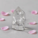 Clear quartz tower with faceted, transparent crystal point