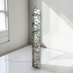 Moss agate obelisk point, slender prism with green-and-cream mottled pattern.