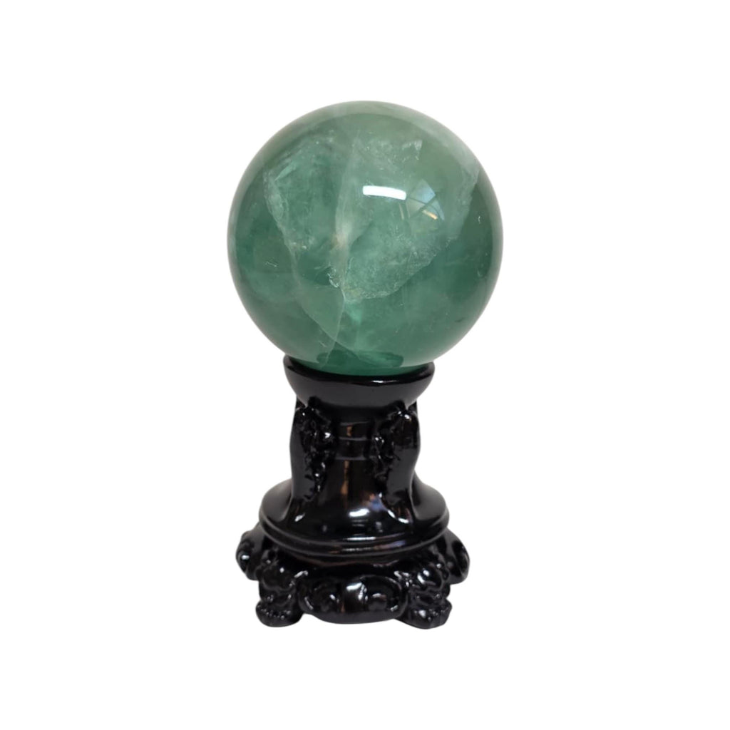 Green fluorite sphere on dark ornate pedestal base, glossy finish