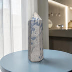 Blue and gray crystal tower with pointed top and speckled blue patches