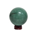 Green crystal sphere on maroon round base, smooth glossy orb