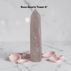 Rose quartz crystal tower in pale pink, tall pointed prism with glossy surface