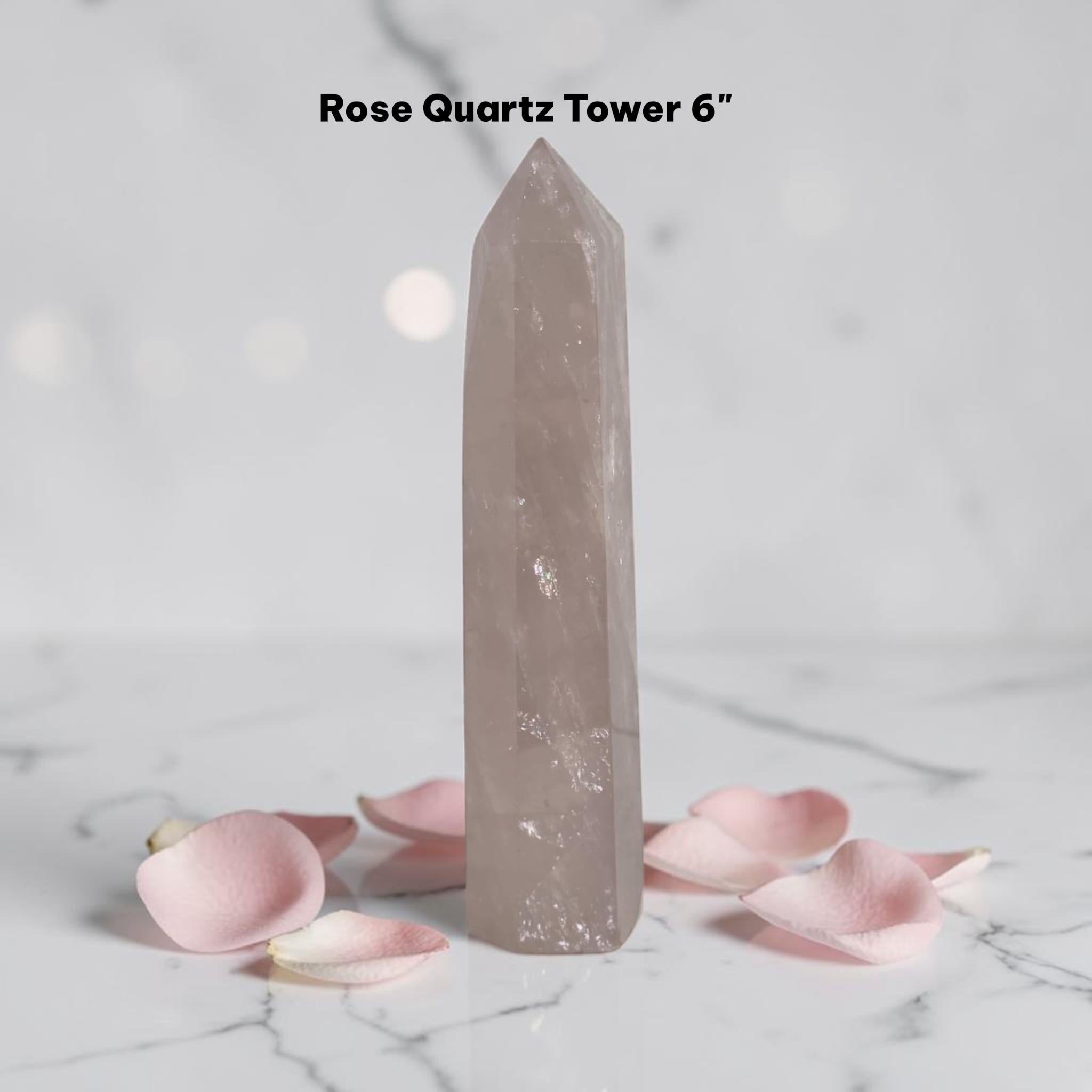 Rose quartz crystal tower in pale pink, tall pointed prism with glossy surface
