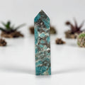 Turquoise blue-green mineral obelisk with pointed top, natural stone texture