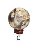 Flower agate drusy sphere on dark red base, gray mineral body with golden crystal highlights