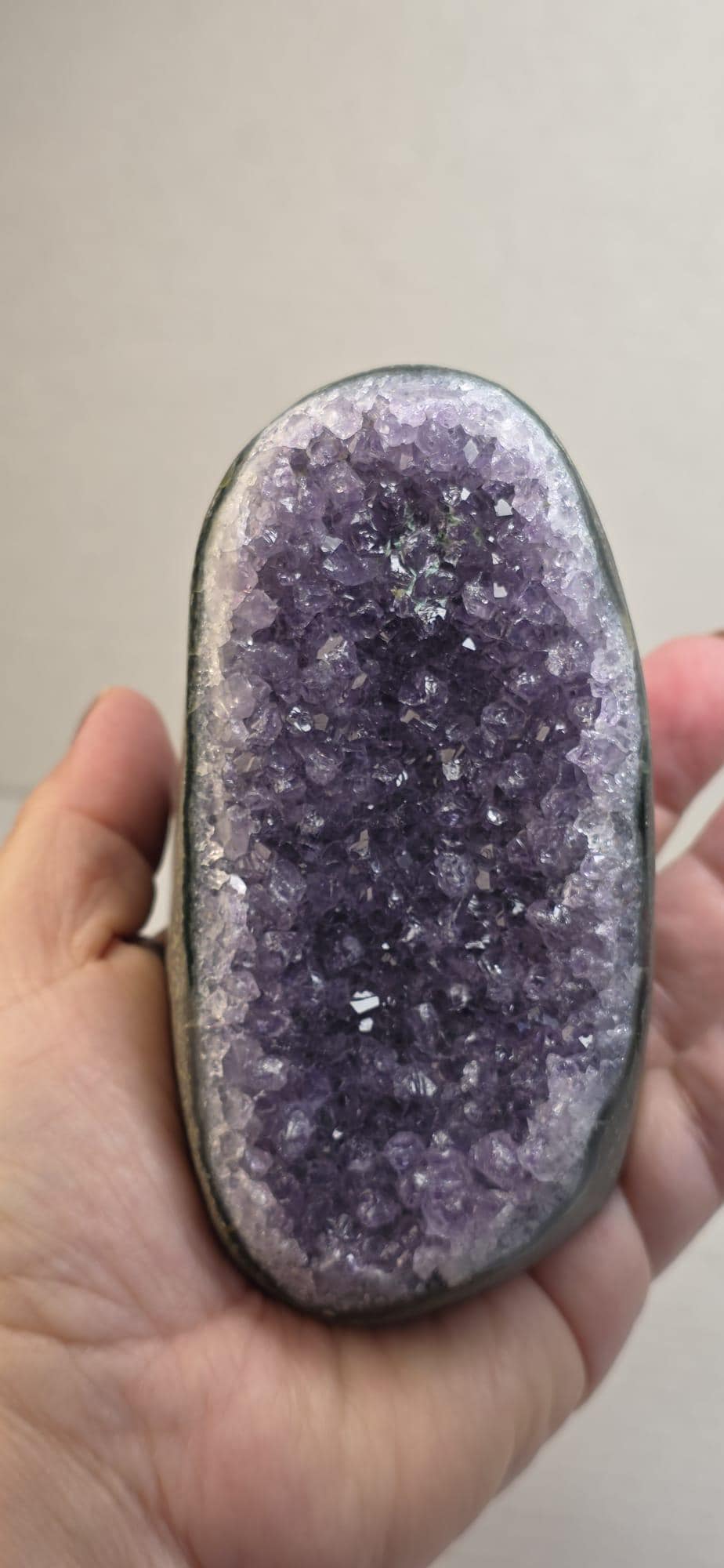 Amethyst druzy freeform crystal with purple sparkling cluster surface, shown close-up