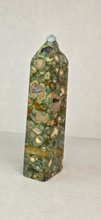 Rainforest jasper druzy tower, tall green stone with tan speckles and dark insets