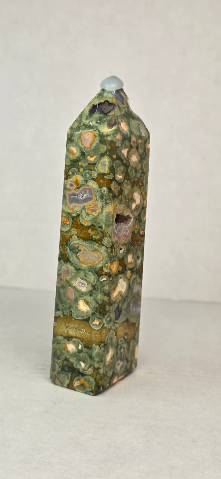 Rainforest jasper druzy tower, tall green stone with tan speckles and dark insets