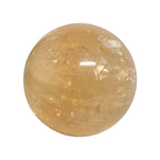 Polished citrine sphere gemstone with warm golden color and glossy reflective surface