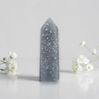 Blue angelite stone tower with white speckle pattern and pointed top.