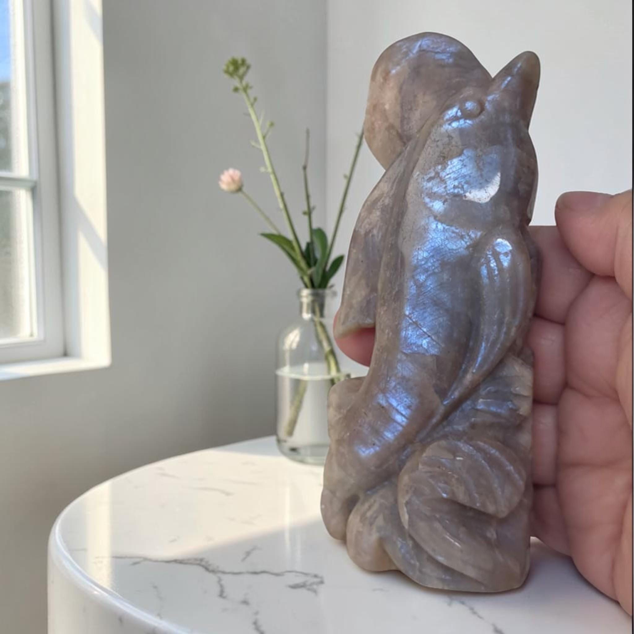 Dolphin crystal sculpture with purple-blue iridescent finish, seated pose with raised tail