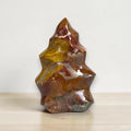 Polished flame-shaped jasper stone, brown and golden swirls with shiny facets