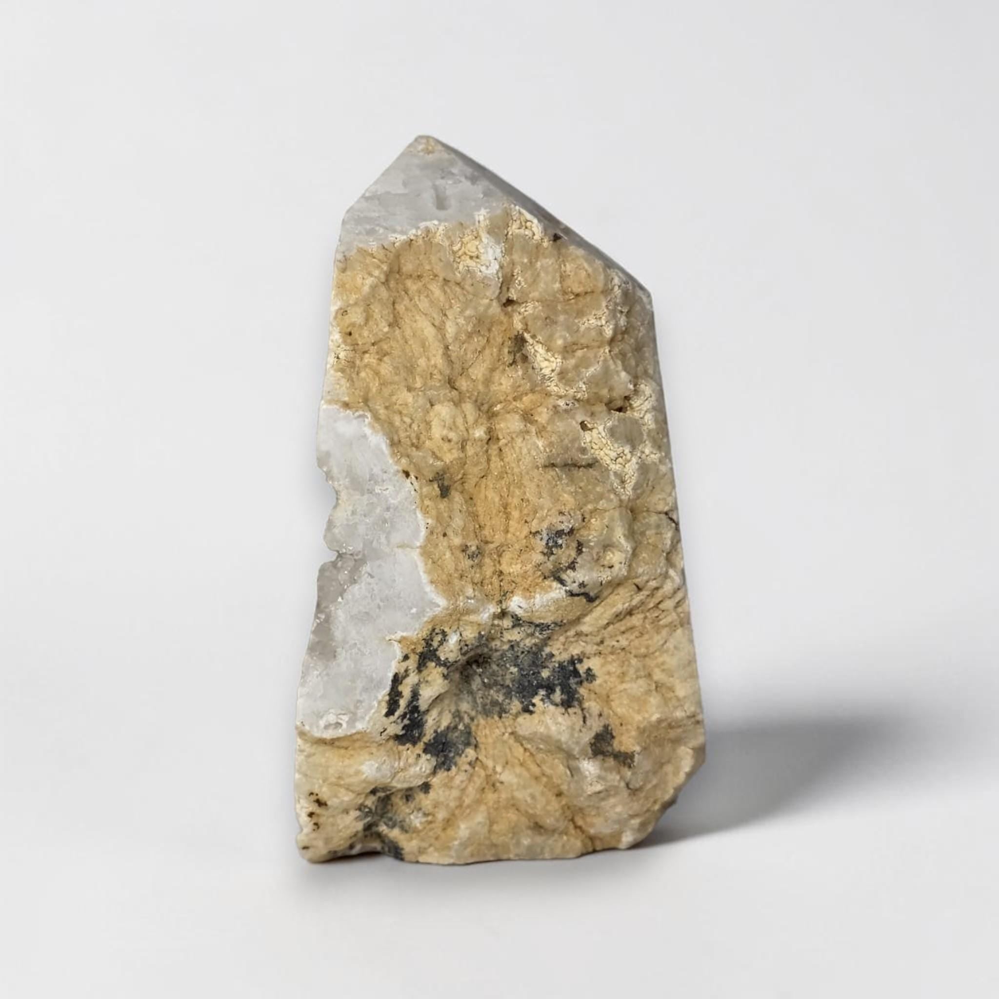Tall quartz drusy geode with tan matrix backing and visible crystal cavity.