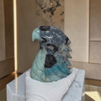 Amazonite eagle head sculpture in blue-gray stone with open wing and textured head