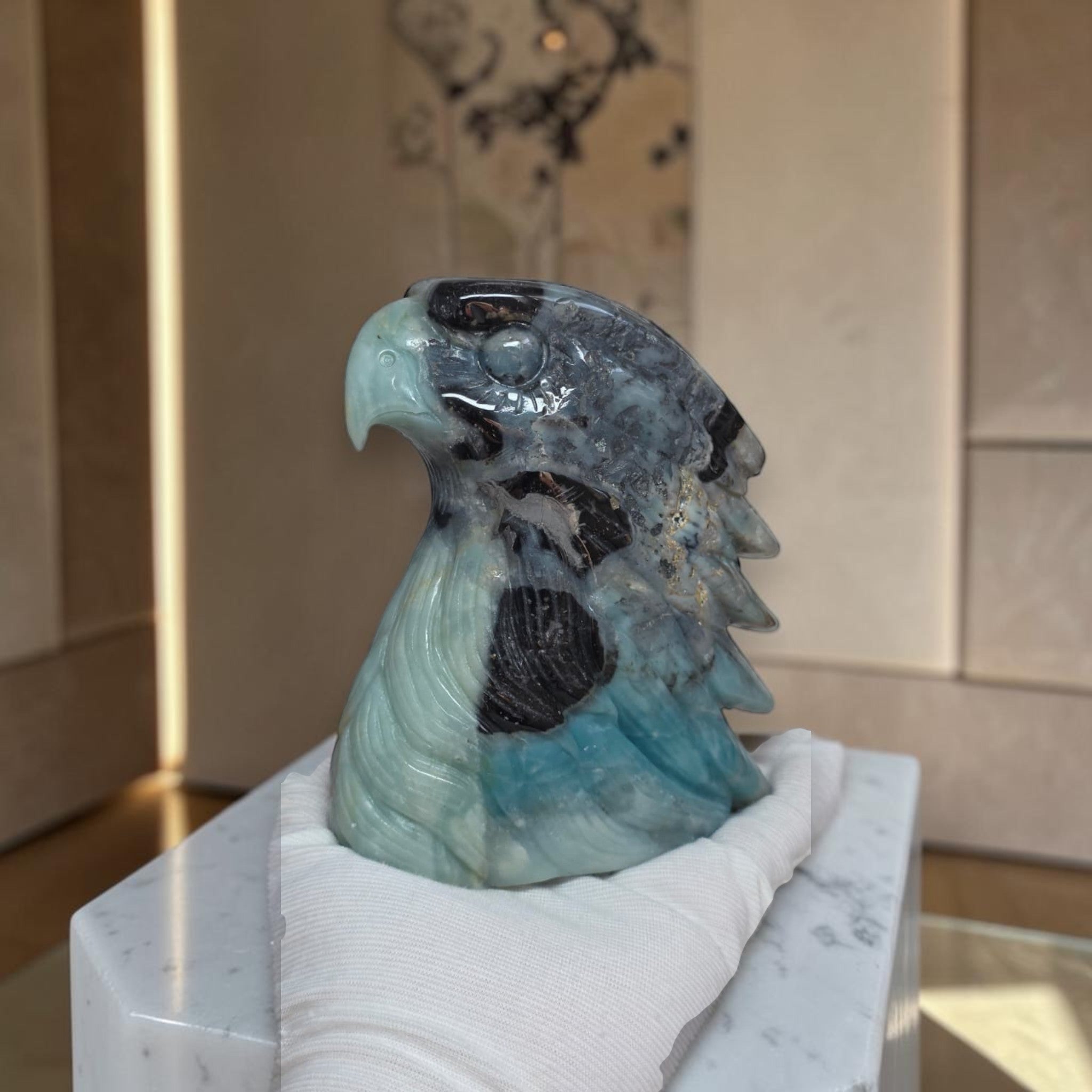 Amazonite eagle head sculpture in blue-gray stone with open wing and textured head