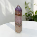 Standing gemstone tower, purple top with wavy orange-tan and pale lavender layers