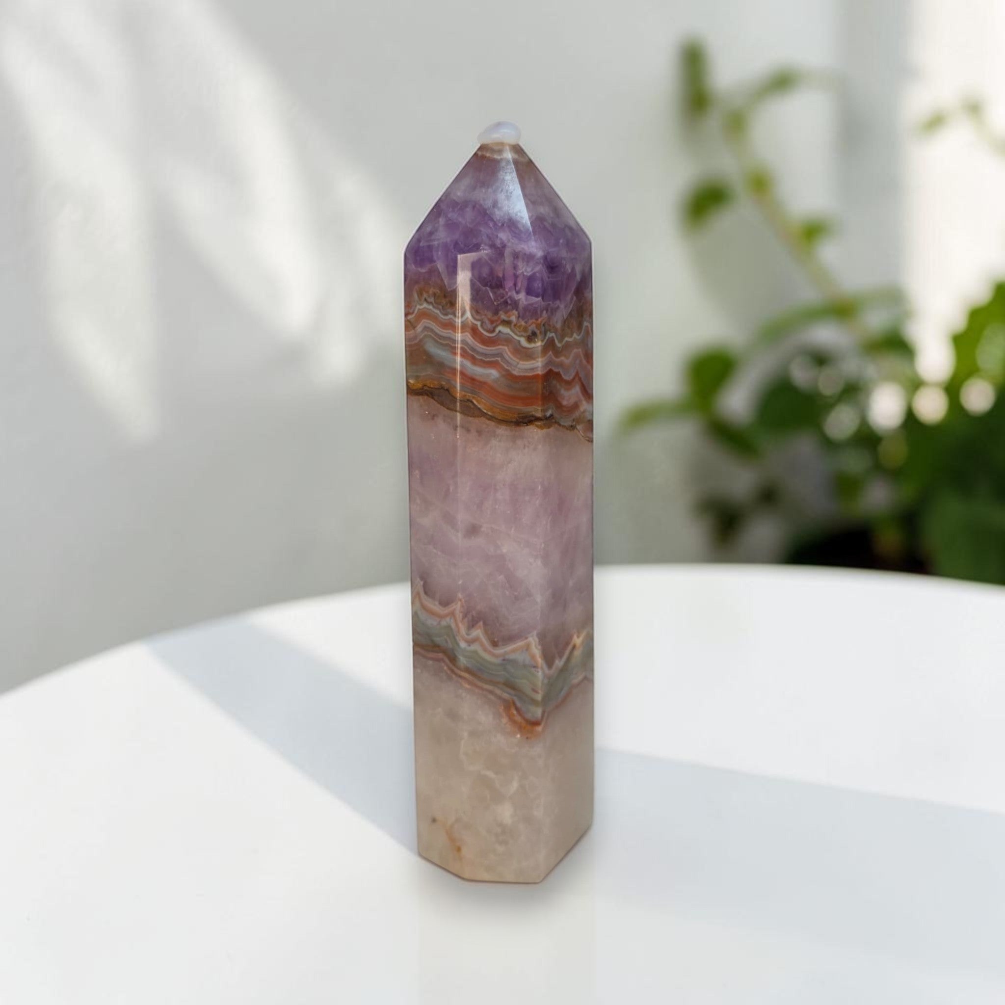 Standing gemstone tower, purple top with wavy orange-tan and pale lavender layers