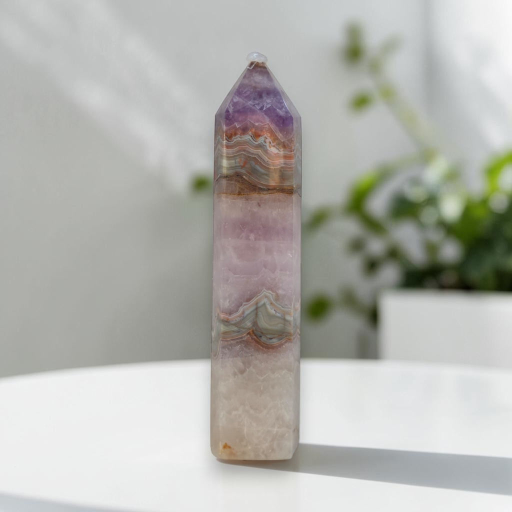 Amethyst-lavender gemstone tower, pale body with tan wavy bands