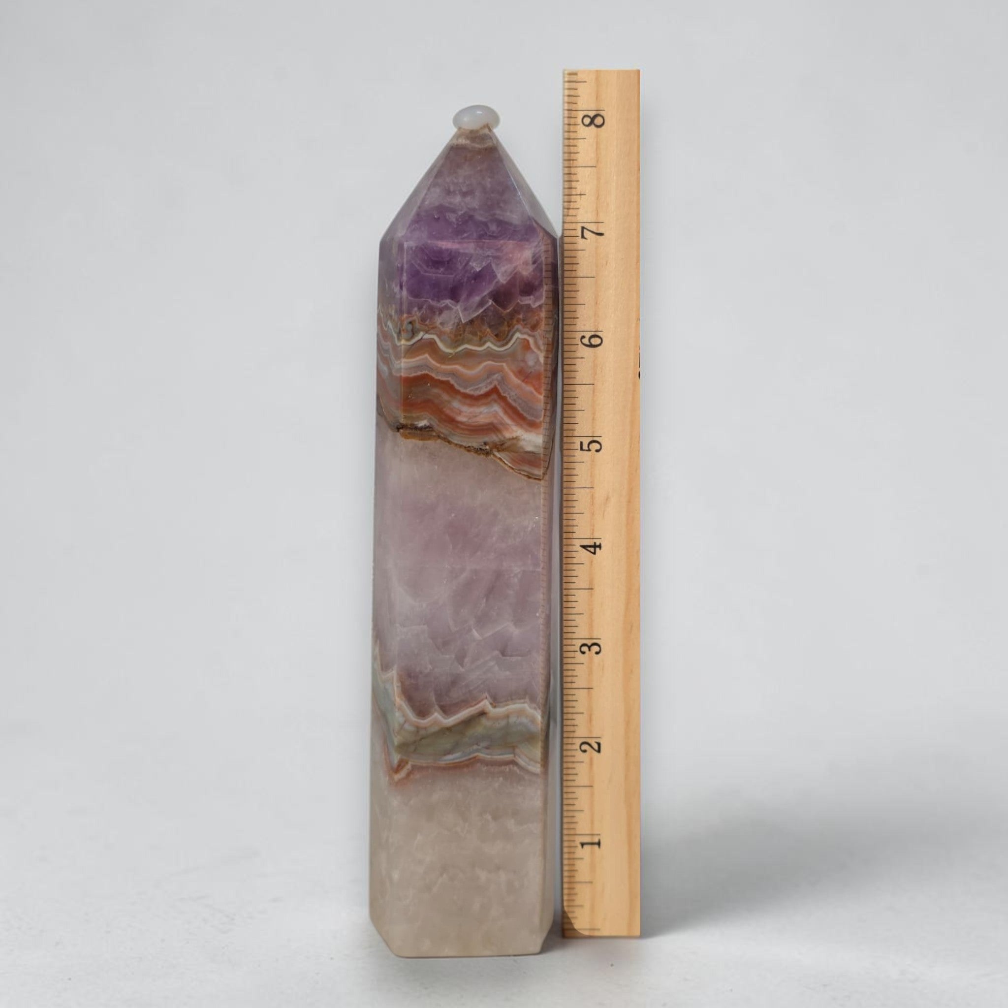 8 in gemstone tower, amethyst purple with lace-like tan bands and faceted tip