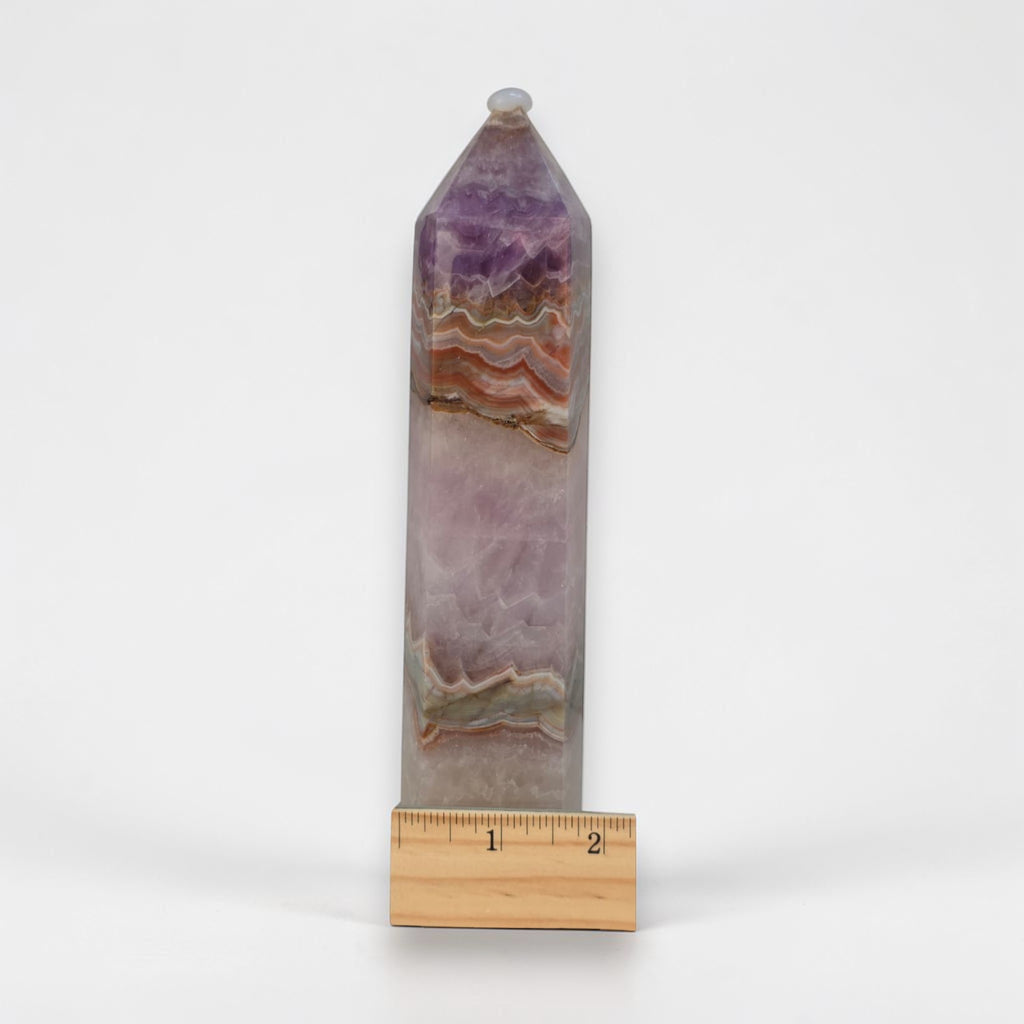 Gemstone tower with faceted top, purple-and-tan lace banding by ruler