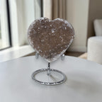 Heart-shaped crystal on a stand in a home setting