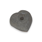 Heart-shaped stone with a central hole on a white background