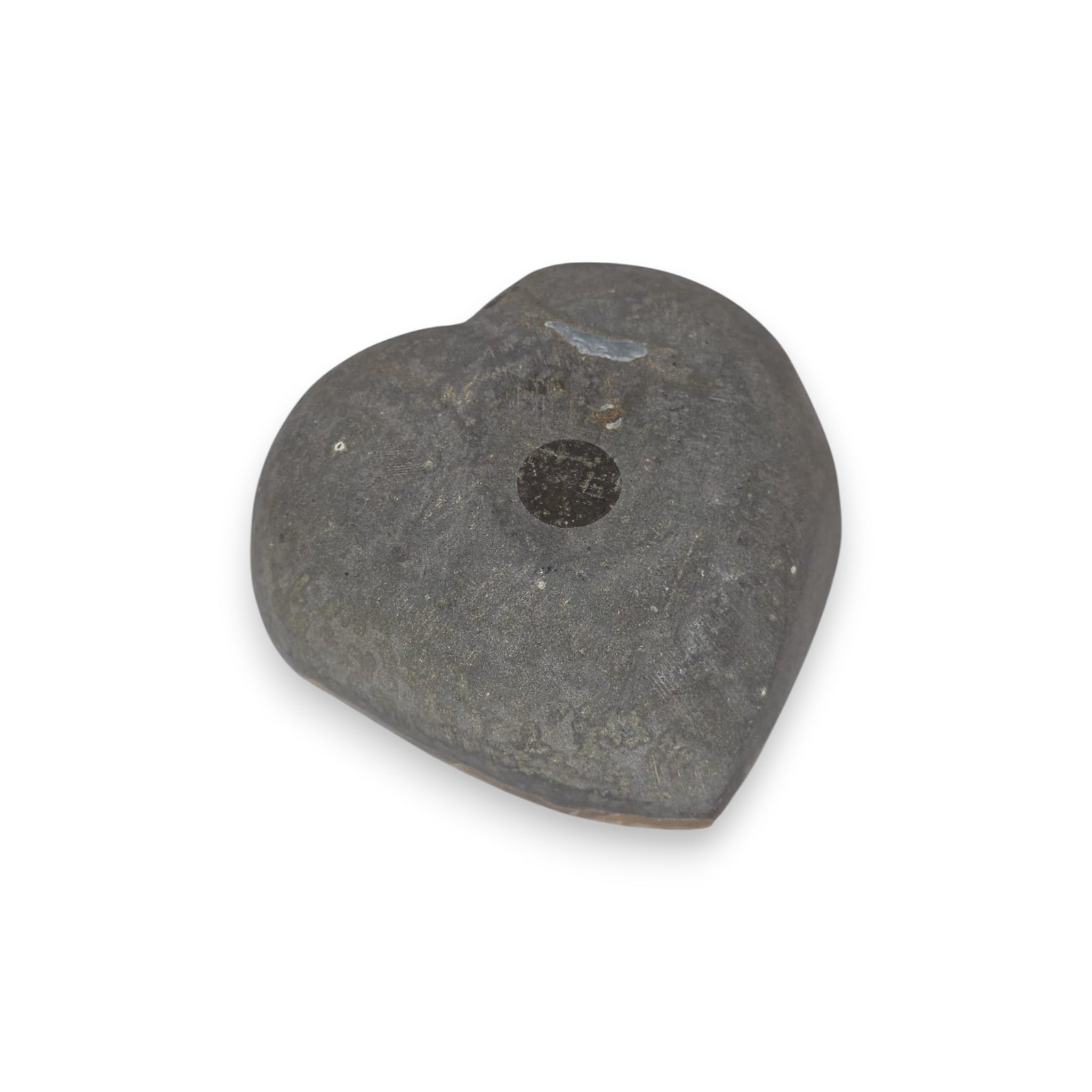 Heart-shaped stone with a central hole on a white background