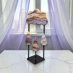 Amethyst lace agate cloud and raindrops sculpture on black metal stand front view