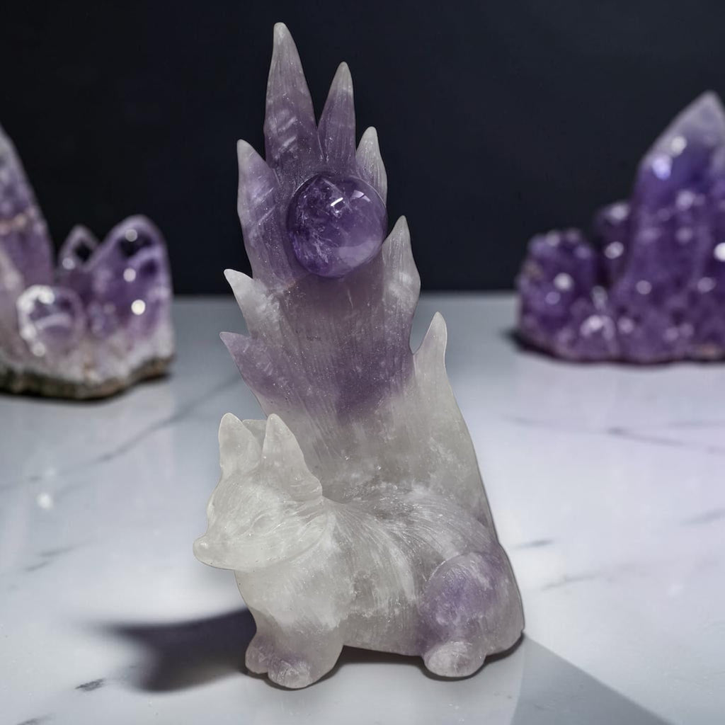 Amethyst nine-tailed fox crystal carving on white marble with amethyst clusters
