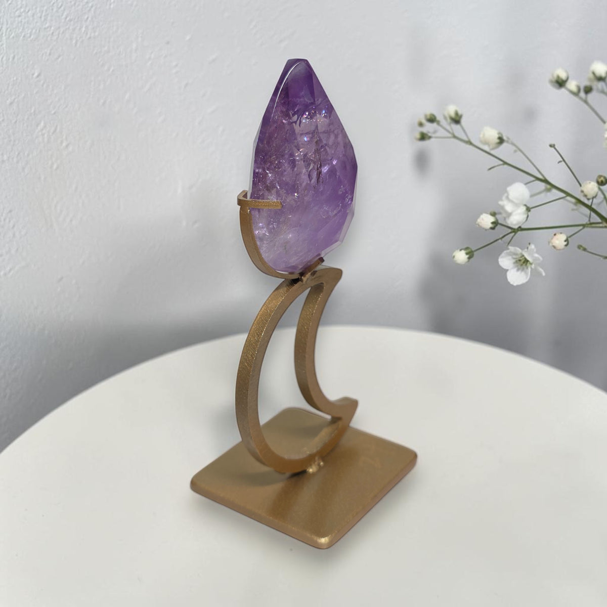 Side view of amethyst teardrop on crescent moon stand