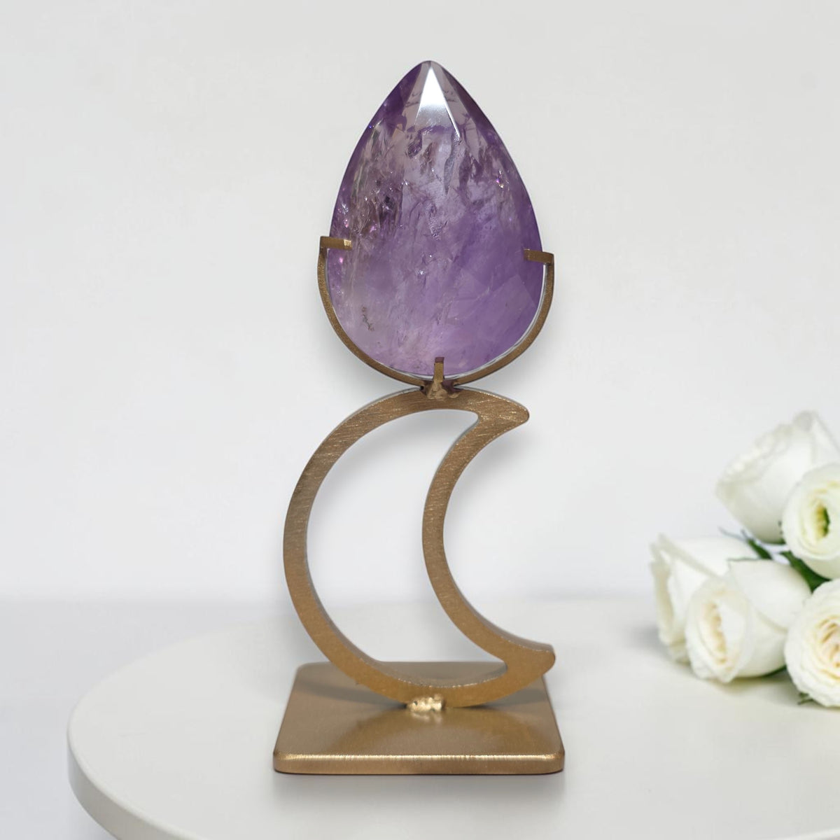 Amethyst teardrop on gold tone crescent moon display