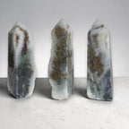 Set of agate drusy crystal towers, pointed tops, white-gray with green and brown mineral bands.