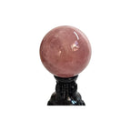 Rose quartz sphere, 73mm, on black stand, polished pink translucent gemstone