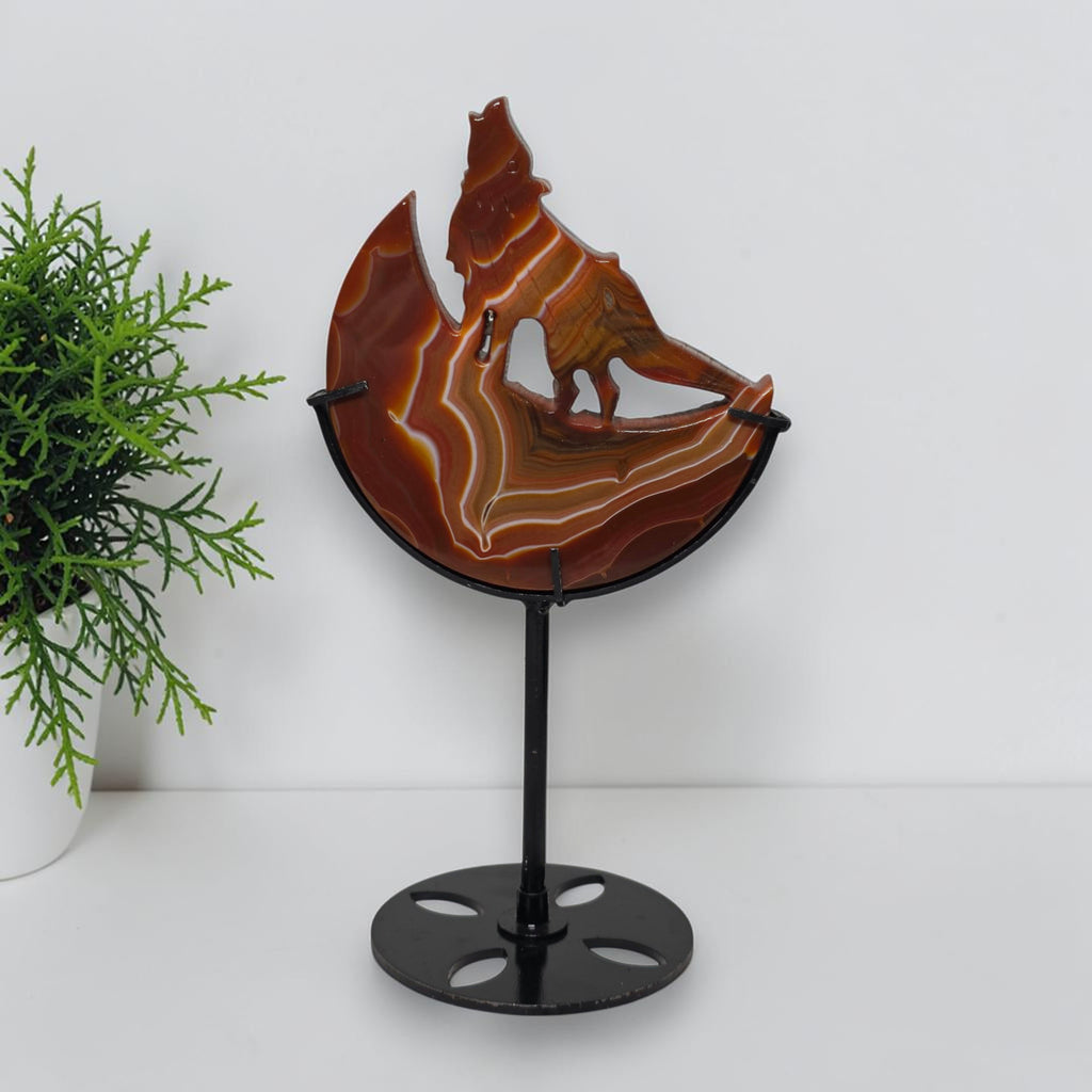 Banded agate wolf moon sculpture on black metal stand