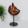 Banded agate wolf moon sculpture on black metal stand
