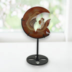 Banded agate moon fairy crystal sculpture on stand, angled view on white piano