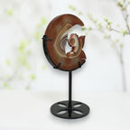 Banded agate moon fairy carving angled view showing warm amber tones and banding patterns