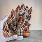 Banded Agate Nine Tails Fox held in hand showing size reference