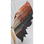 Polished agate butterfly wing held in a hand