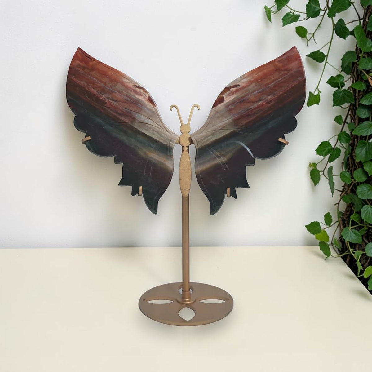 Red and black agate butterfly on a gold toned display stand