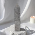 Gray rutilated quartz obelisk tower with dark needle inclusions and pointed top