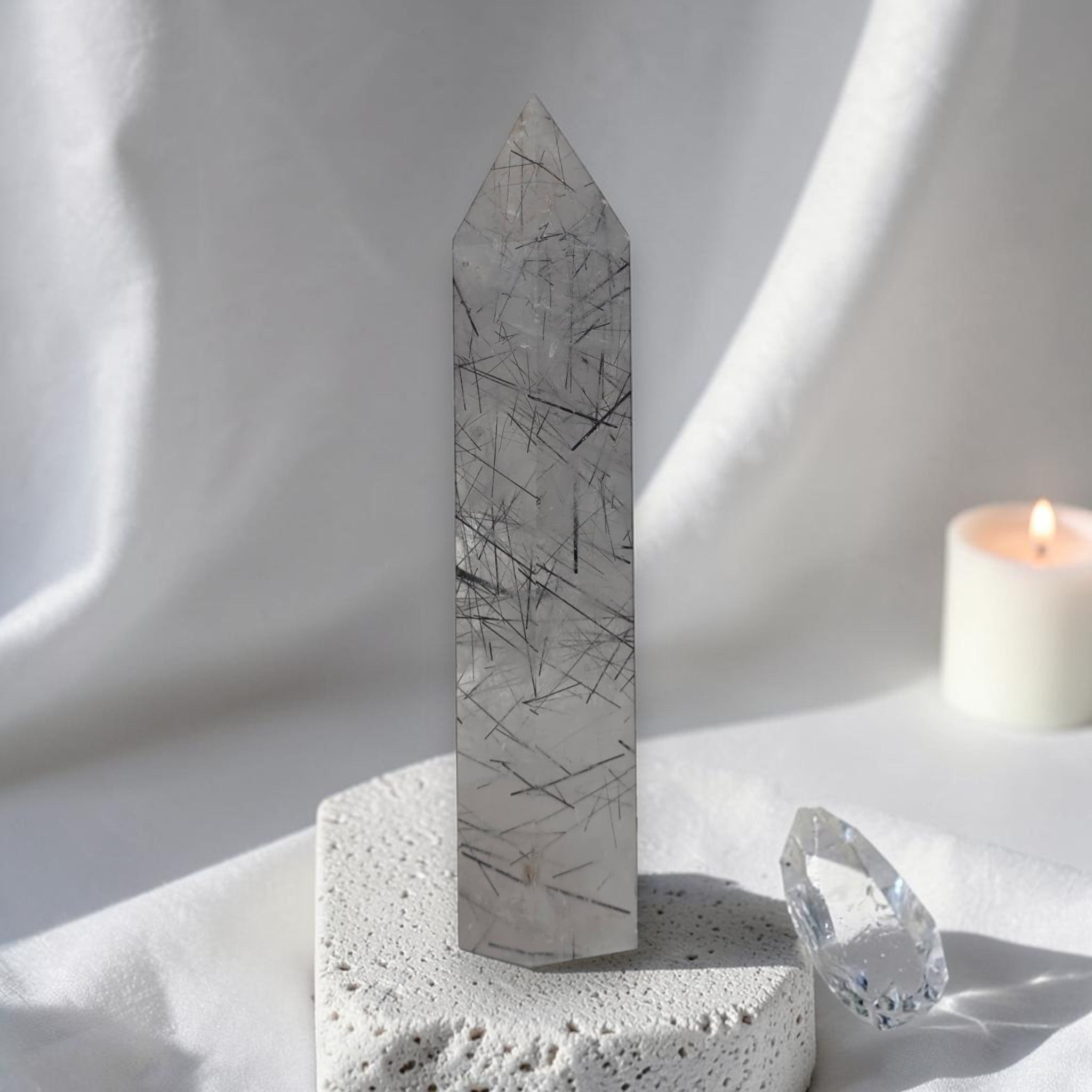 Gray rutilated quartz obelisk tower with dark needle inclusions and pointed top