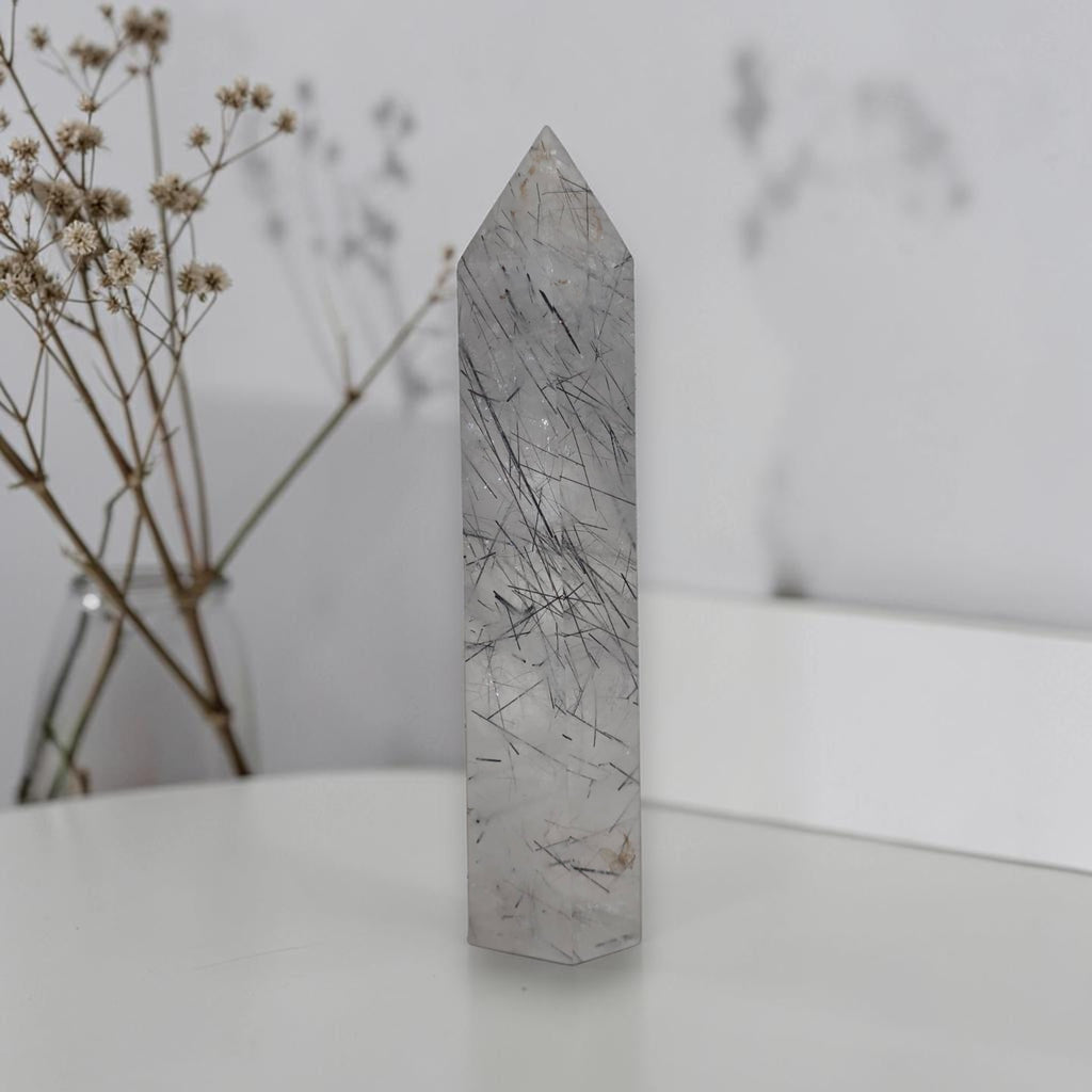 Rutilated quartz obelisk tower with gray crystal body and dark needle inclusions